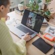 Person editing a photo on a laptop using creative software at a desk