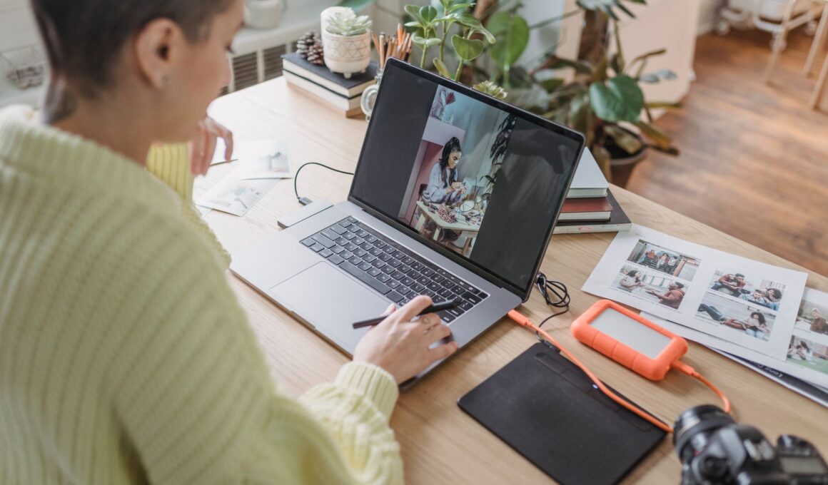 Person editing a photo on a laptop using creative software at a desk