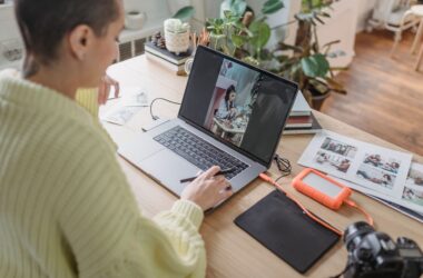 Person editing a photo on a laptop using creative software at a desk