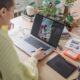 Person editing a photo on a laptop using creative software at a desk