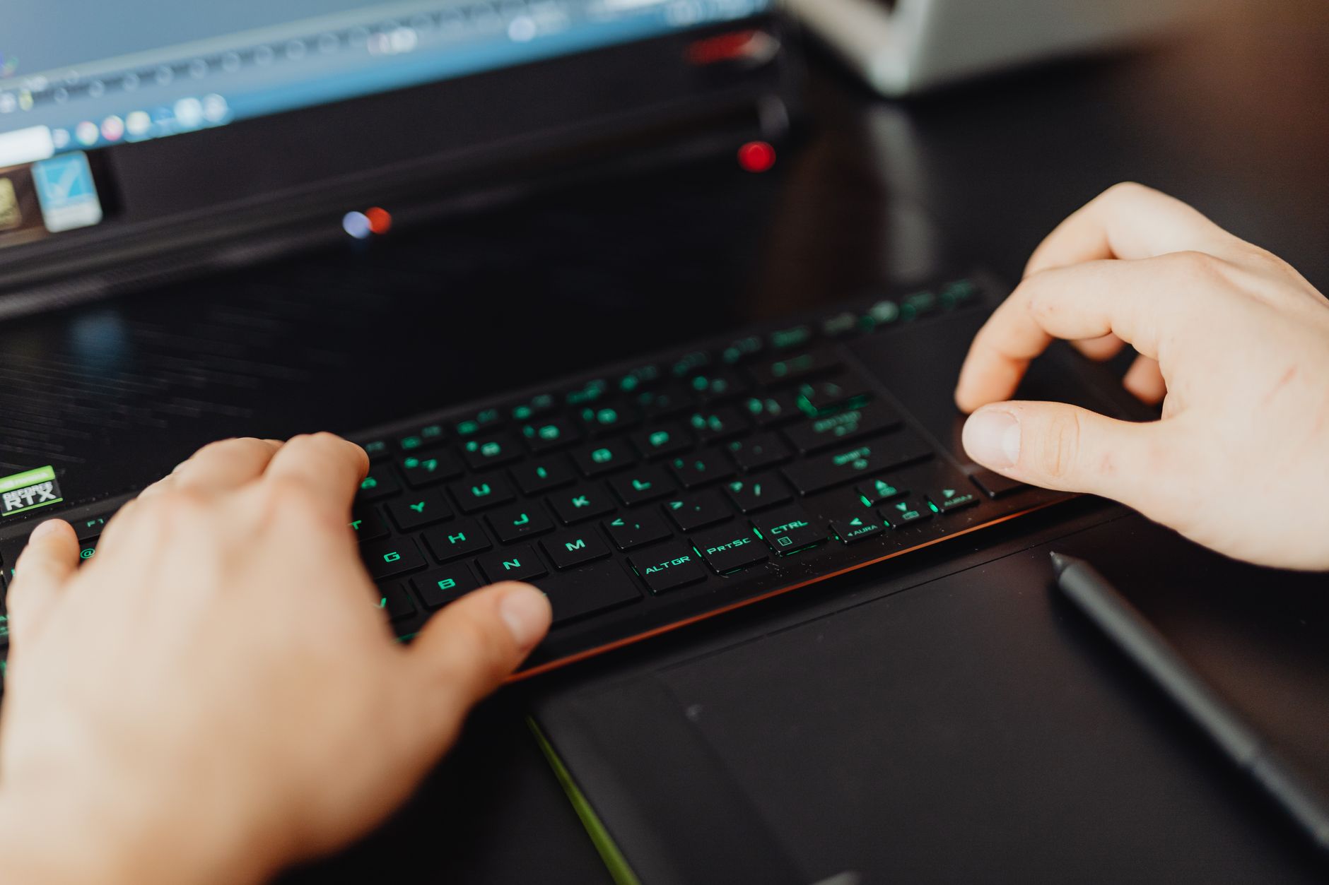 Close-up of a software developer's hands typing code on a laptop keyboard
