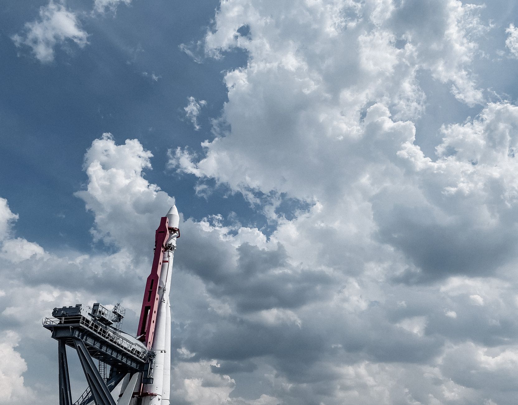 A tall rocket standing on a launchpad ready for liftoff