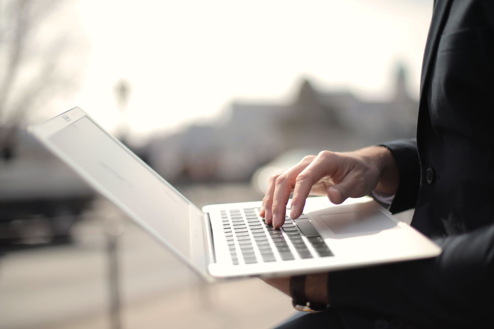 A person reviewing financial information on a laptop at a desk